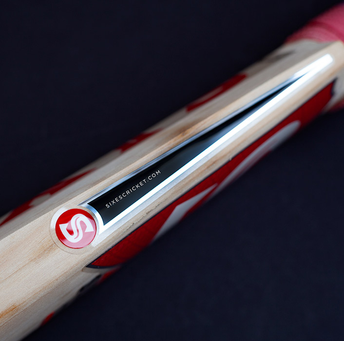 Sixes Social Cricket — Spine Detail — Silver Foil Striping and Roundel